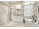 Elegant bathroom with a soaking tub, glass-enclosed shower, and dual sinks at 27953 N 111Th Way, Scottsdale, AZ 85262