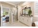 Bright bathroom with a glass shower, granite countertops, and refined white cabinets at 27953 N 111Th Way, Scottsdale, AZ 85262