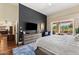 Inviting bedroom showcasing a dark accent wall, wood floors, and access to an outdoor patio at 27953 N 111Th Way, Scottsdale, AZ 85262