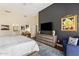 Spacious bedroom featuring hardwood floors, a modern dresser, and a serene seating area at 27953 N 111Th Way, Scottsdale, AZ 85262