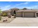 Charming home featuring a tile roof, three-car garage, and desert landscaping at 27953 N 111Th Way, Scottsdale, AZ 85262