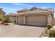Home exterior featuring a tile roof and spacious three-car garage at 27953 N 111Th Way, Scottsdale, AZ 85262