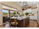 Kitchen island featuring stone countertop, bar stool seating, and sliding glass doors to the patio at 27953 N 111Th Way, Scottsdale, AZ 85262