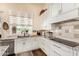 Bright kitchen featuring white cabinets, granite counters, and stainless steel dishwasher at 27953 N 111Th Way, Scottsdale, AZ 85262