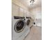 Well-equipped laundry room with modern appliances and ample cabinet space at 27953 N 111Th Way, Scottsdale, AZ 85262