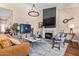 Spacious living room with a cozy fireplace, comfortable seating, and elegant accents at 27953 N 111Th Way, Scottsdale, AZ 85262