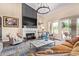 Bright and inviting living room featuring a fireplace, large windows, and stylish decor at 27953 N 111Th Way, Scottsdale, AZ 85262