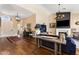 Open concept living room with hardwood floors and a fireplace at 27953 N 111Th Way, Scottsdale, AZ 85262