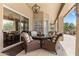 Inviting outdoor patio featuring comfortable wicker furniture, a glass table, and an outdoor grill at 27953 N 111Th Way, Scottsdale, AZ 85262