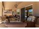 Inviting outdoor patio with comfortable seating, a glass table, and views of the backyard at 27953 N 111Th Way, Scottsdale, AZ 85262