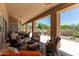 Covered patio with ample seating and views of the luxurious pool and backyard at 27953 N 111Th Way, Scottsdale, AZ 85262