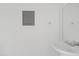 Clean bathroom featuring a pedestal sink, mirror, and neutral color scheme at 286 W Palomino Dr # 103, Chandler, AZ 85225