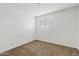 This carpeted bedroom features a bright window and neutral walls at 286 W Palomino Dr # 103, Chandler, AZ 85225