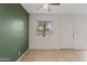 Cozy living space with neutral tile flooring, ceiling fan, and bright window at 286 W Palomino Dr # 103, Chandler, AZ 85225