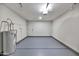 An empty garage with freshly painted floor, new lighting, and storage at 3026 W Ross Ave, Phoenix, AZ 85027