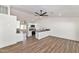 Open-concept living space with white cabinets and stainless steel appliances at 3026 W Ross Ave, Phoenix, AZ 85027