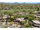 Aerial view of desert home with mature landscaping, and a golf course in the background at 3120 Arroyo Hondo --, Carefree, AZ 85377