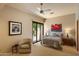 Serene bedroom with a ceiling fan, comfortable furnishings, and abundant natural light from sliding glass doors at 3120 Arroyo Hondo --, Carefree, AZ 85377