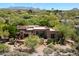 Desert home showcasing unique stone detail, lush trees, and scenic mountain views at 3120 Arroyo Hondo --, Carefree, AZ 85377