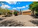 Stunning exterior view of a Southwestern-style home with a large driveway and mature desert landscaping at 3120 Arroyo Hondo --, Carefree, AZ 85377