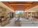 Spacious living room with stone fireplace, wood beam ceiling, desert views and an open floor plan at 3120 Arroyo Hondo --, Carefree, AZ 85377