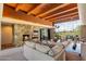 Spacious living room with stone fireplace, beamed ceilings, and expansive windows showcasing desert views at 3120 Arroyo Hondo --, Carefree, AZ 85377