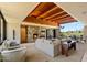 Open living room with a stone fireplace, beamed ceilings, and panoramic views of the natural landscape at 3120 Arroyo Hondo --, Carefree, AZ 85377