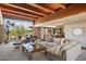 Bright living room with an open floor plan, desert view windows, wood beam ceiling, and comfortable seating at 3120 Arroyo Hondo --, Carefree, AZ 85377