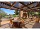 Outdoor patio featuring a stone fireplace, desert views, and comfortable seating arrangement at 3120 Arroyo Hondo --, Carefree, AZ 85377