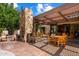 Spacious outdoor patio with a stone fireplace, grill, and desert landscape at 3120 Arroyo Hondo --, Carefree, AZ 85377