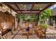 Inviting outdoor patio with stone fireplace, pergola, and comfortable seating area at 3120 Arroyo Hondo --, Carefree, AZ 85377