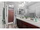 This spacious bathroom features double sinks and a well-lit mirror with a view of the shower at 3272 E Orchid Ln, Gilbert, AZ 85296