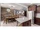 Open concept kitchen flowing into the dining and living areas, featuring a large center island at 3272 E Orchid Ln, Gilbert, AZ 85296
