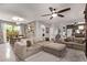 Open concept living room with modern decor, plush sectional sofa, and view of dining area and stairs at 3272 E Orchid Ln, Gilbert, AZ 85296