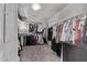 Organized walk-in closet with ample hanging space and shelving for clothing and accessories at 3272 E Orchid Ln, Gilbert, AZ 85296