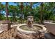 Lovely water feature with stone surround and landscaping in community park at 3272 E Orchid Ln, Gilbert, AZ 85296