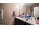 Bathroom featuring a double sink vanity, a large mirror, and neutral wall colors at 33013 N Ash Tree Ln, San Tan Valley, AZ 85144
