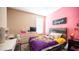 Charming bedroom with light pink walls, and a sunny window at 33013 N Ash Tree Ln, San Tan Valley, AZ 85144