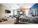 Cozy bedroom featuring a ceiling fan, large windows, and neutral walls at 33013 N Ash Tree Ln, San Tan Valley, AZ 85144