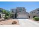 Charming home with desert landscape, two-car garage, and covered porch at 33013 N Ash Tree Ln, San Tan Valley, AZ 85144