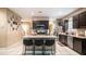 Well-lit kitchen with large island with bar stool seating at 33013 N Ash Tree Ln, San Tan Valley, AZ 85144