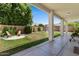 Large backyard area with covered patio, mature trees, and outdoor seating for relaxing and entertaining at 3784 E Washington Ct, Gilbert, AZ 85234