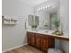 Elegant bathroom features a double sink vanity and wood-look vinyl flooring at 3784 E Washington Ct, Gilbert, AZ 85234