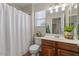 Cozy bathroom featuring a shower with curtain, vanity and window view at 3784 E Washington Ct, Gilbert, AZ 85234