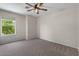 Neutral bedroom with a ceiling fan and natural light from the exterior window at 3784 E Washington Ct, Gilbert, AZ 85234