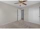 Bedroom with neutral carpet, ceiling fan and large closet with sliding doors at 3784 E Washington Ct, Gilbert, AZ 85234