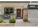 Cozy front porch with brick columns, a seating area, and a welcoming front door with a decorative wreath at 3784 E Washington Ct, Gilbert, AZ 85234