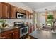 Well-lit kitchen featuring granite countertops and stainless steel appliances at 3784 E Washington Ct, Gilbert, AZ 85234