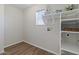 Well-organized laundry room featuring shelving, a window, and wood flooring at 3784 E Washington Ct, Gilbert, AZ 85234