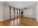 Expansive living room with wood floors, ceiling fan, and natural light from large windows at 3784 E Washington Ct, Gilbert, AZ 85234